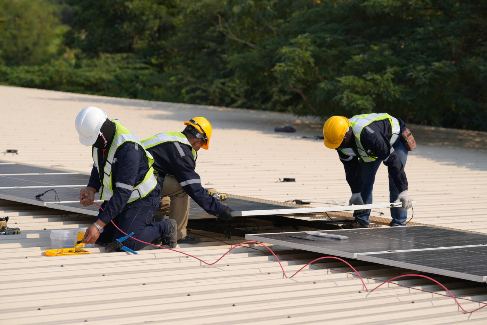 Engineer installing solar cell panels on roof.